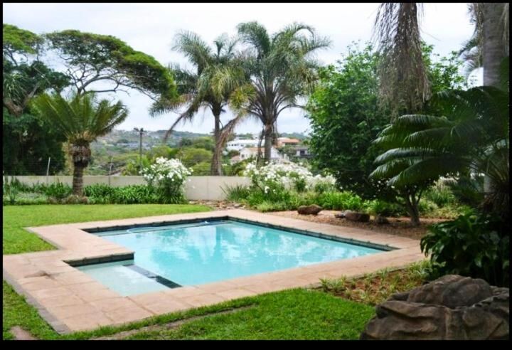 Swimming pool and tropical garden at Mahogany Villa
